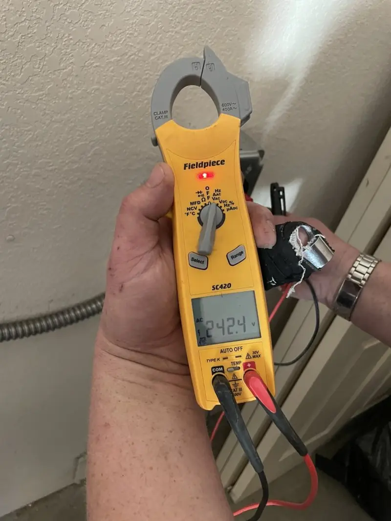Voltage testing with clamp meter during Outlet Installation in Grayson